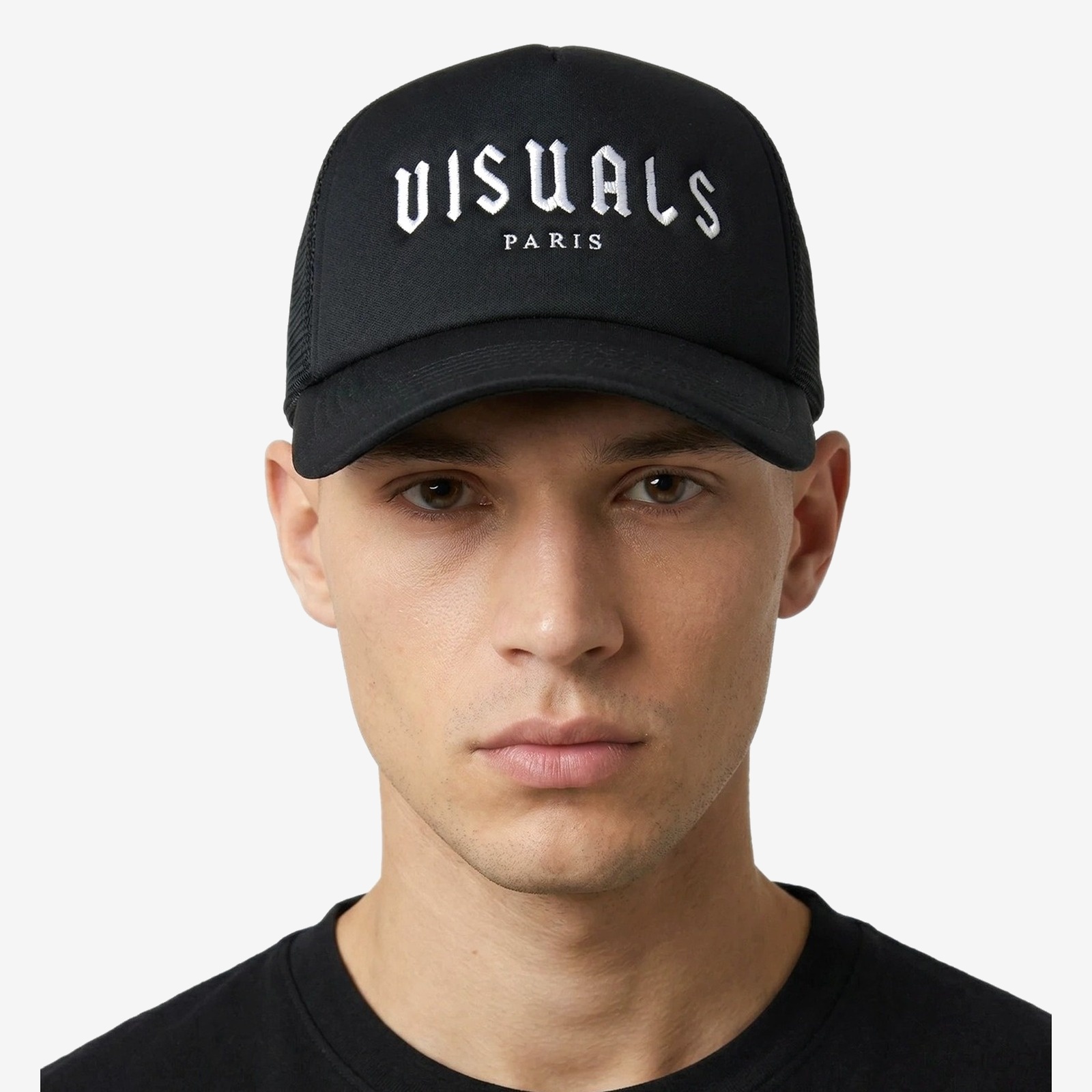 Blanc Trucker Cap in Black — worn by a model