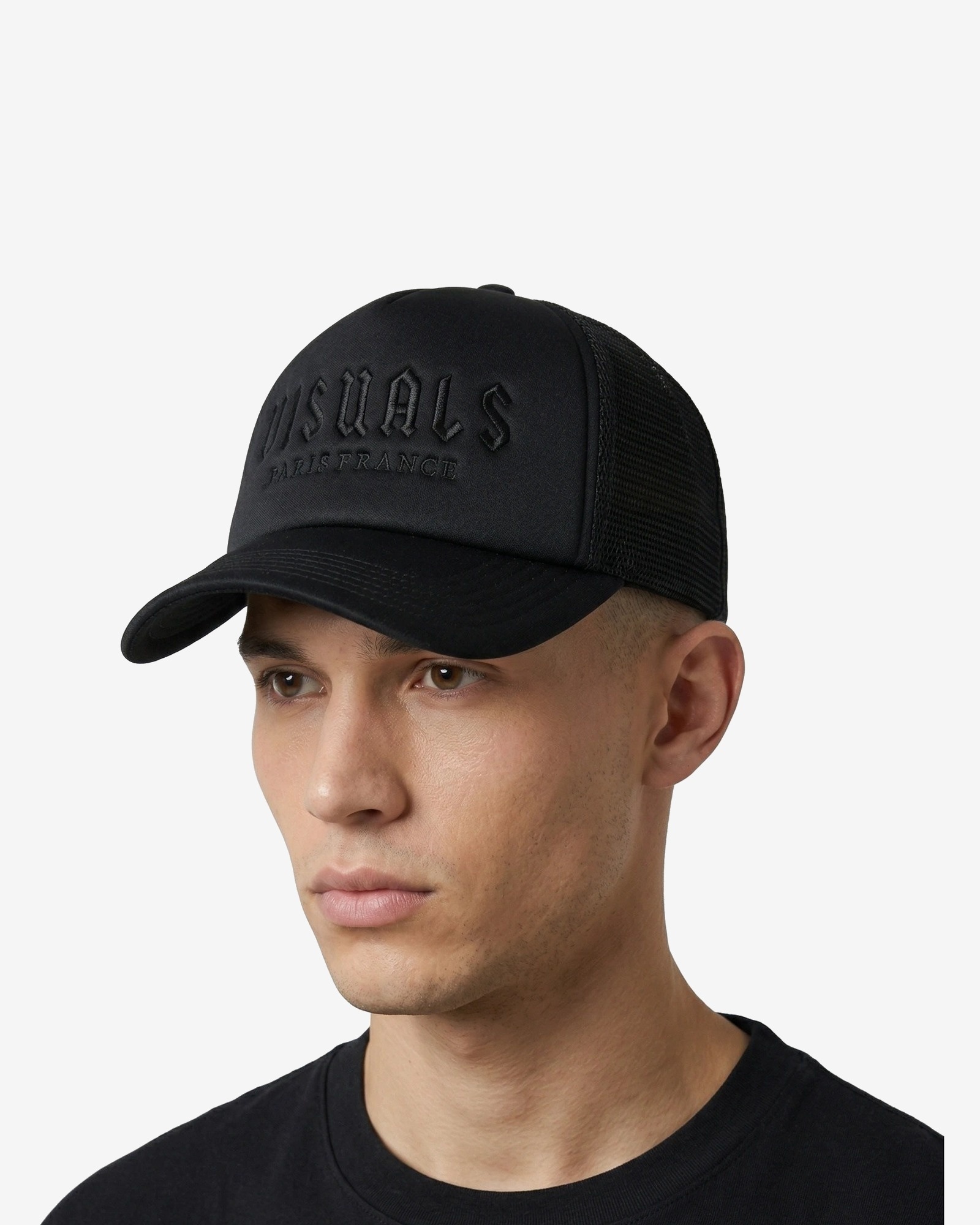 Noir Signature Trucker Cap in Tonal Black — worn by a model